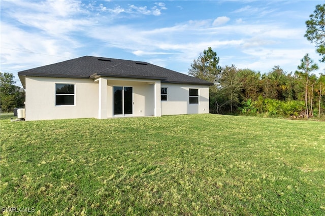 back of house with a lawn