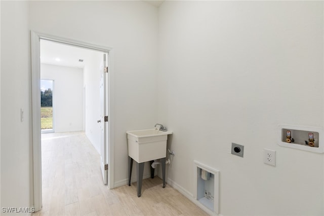 washroom featuring light hardwood / wood-style floors, hookup for an electric dryer, and hookup for a washing machine