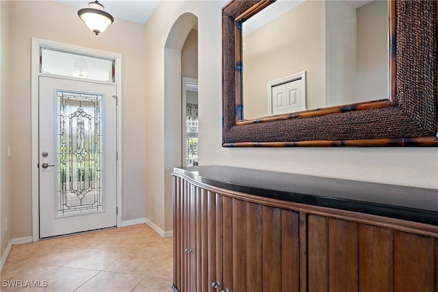 entryway with a healthy amount of sunlight and light tile patterned floors