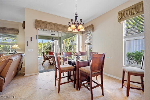 tiled dining room with a wealth of natural light and a chandelier