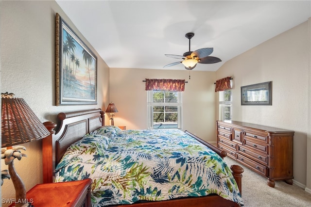 carpeted bedroom featuring ceiling fan and vaulted ceiling