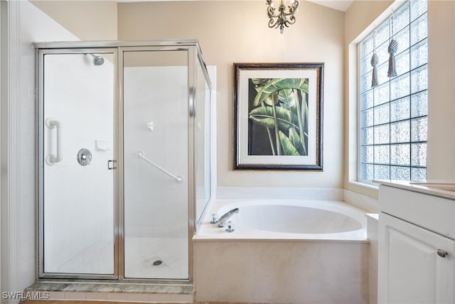 bathroom featuring vanity and separate shower and tub