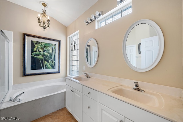 bathroom featuring vanity, lofted ceiling, a bathtub, an inviting chandelier, and tile patterned flooring