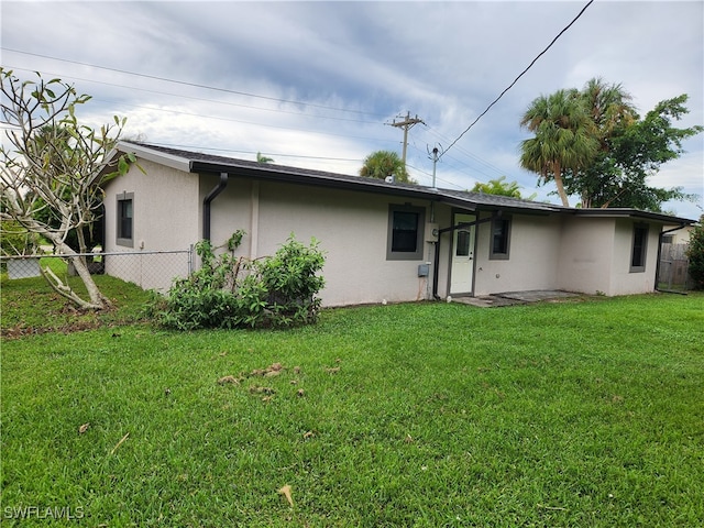 rear view of house with a yard