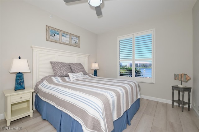 bedroom with ceiling fan and light hardwood / wood-style flooring