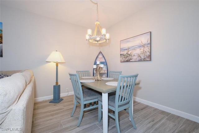 dining area with a chandelier and light hardwood / wood-style flooring