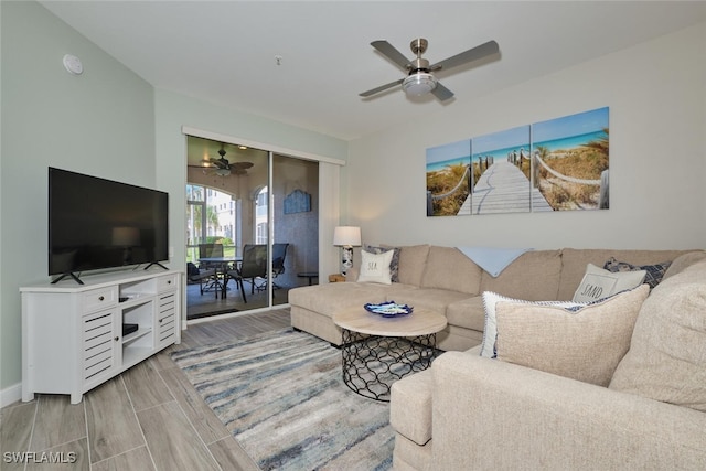 living room with light hardwood / wood-style floors and ceiling fan