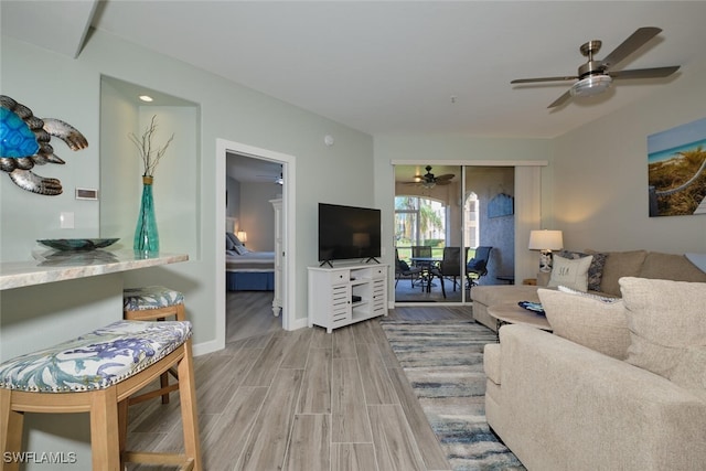 living room with wood-type flooring and ceiling fan