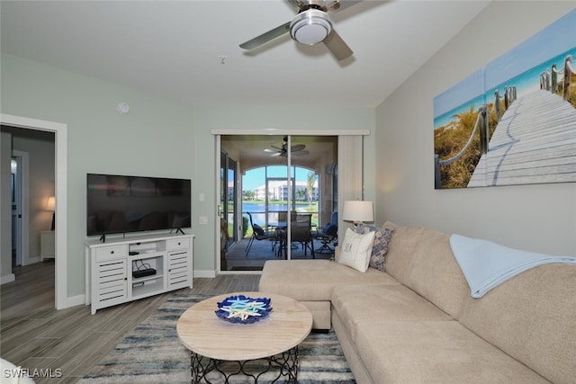 living room featuring hardwood / wood-style floors and ceiling fan