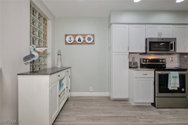 kitchen featuring white cabinetry, light hardwood / wood-style floors, and appliances with stainless steel finishes