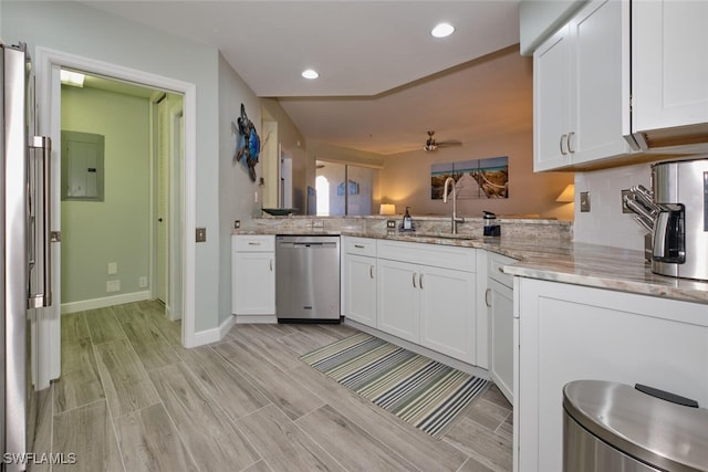 kitchen with white cabinetry, kitchen peninsula, sink, and stainless steel dishwasher