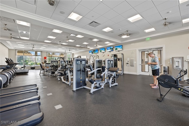 workout area featuring a paneled ceiling and ceiling fan