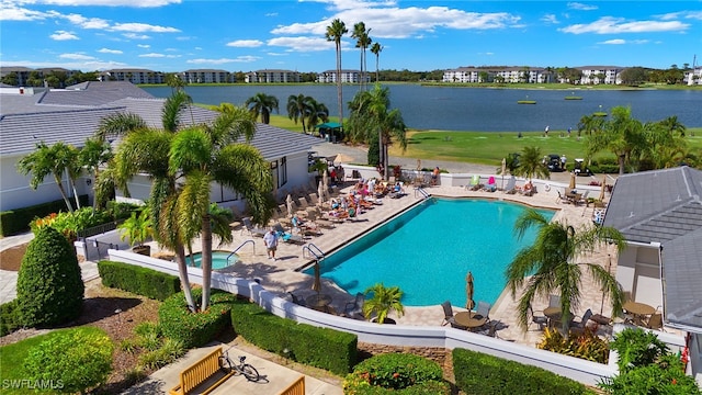 view of pool featuring a patio and a water view