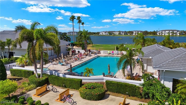 view of swimming pool with a patio and a water view