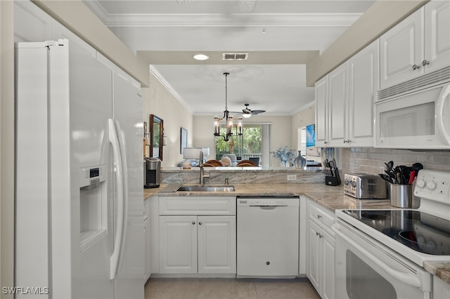 kitchen with white appliances, an inviting chandelier, sink, and white cabinets