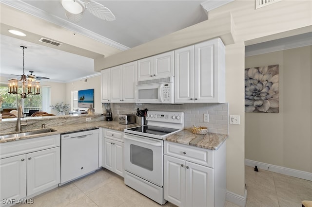 kitchen with ornamental molding, white cabinets, sink, and white appliances