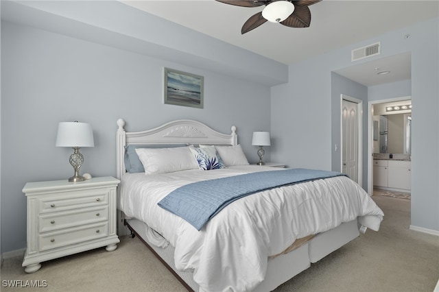 carpeted bedroom featuring ensuite bath and ceiling fan