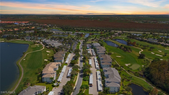 aerial view at dusk with a water view