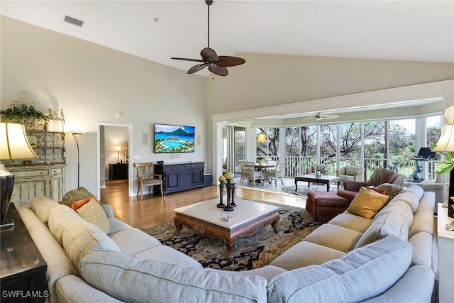 living room featuring ceiling fan, a healthy amount of sunlight, and light hardwood / wood-style flooring