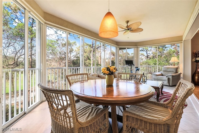 sunroom featuring ceiling fan