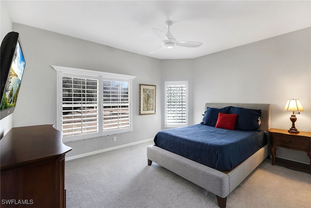 bedroom featuring light carpet and ceiling fan