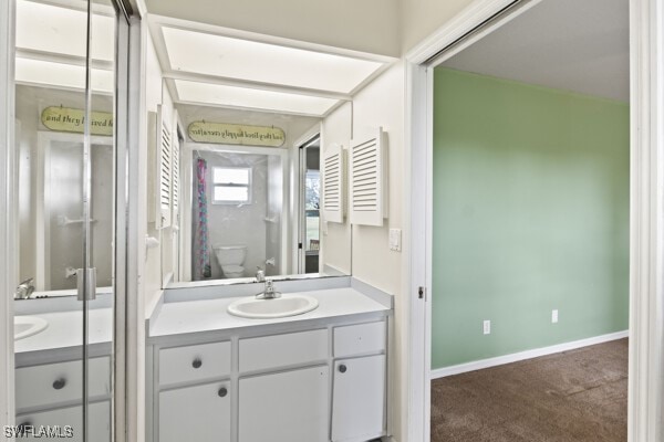 bathroom featuring vanity and toilet