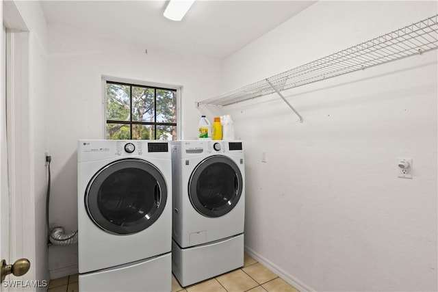 clothes washing area with light tile patterned flooring and independent washer and dryer