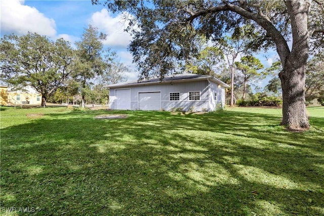 view of yard with an outbuilding and a garage