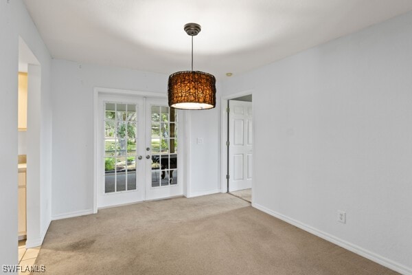 carpeted spare room with french doors