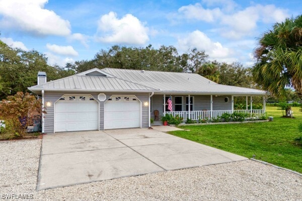 ranch-style home with a porch, a front yard, and a garage