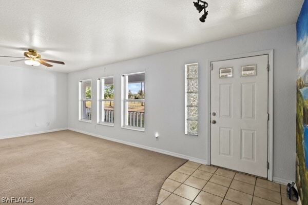 tiled entrance foyer featuring ceiling fan