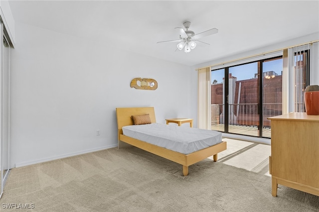 unfurnished bedroom featuring access to outside, ceiling fan, and light colored carpet