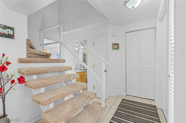 staircase featuring tile patterned floors