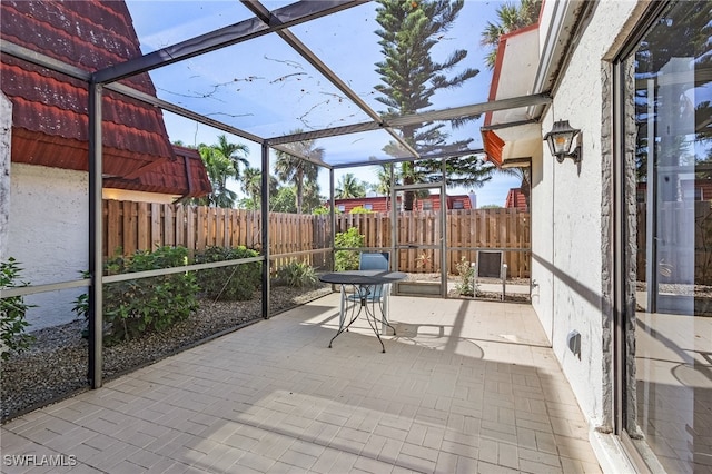 view of patio / terrace featuring a lanai