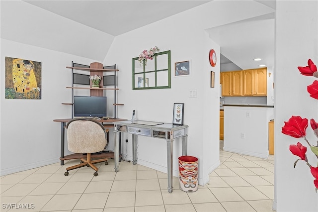 office space featuring light tile patterned floors and vaulted ceiling