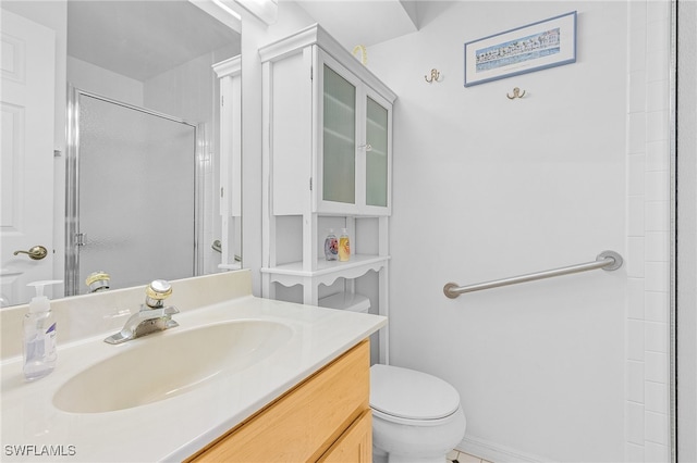 bathroom with vanity, a shower with shower door, and toilet