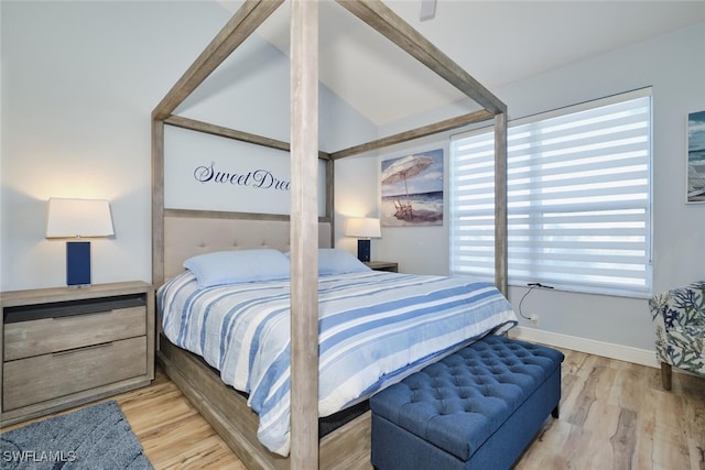 bedroom featuring vaulted ceiling and wood-type flooring