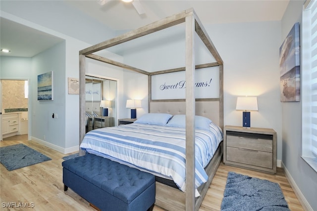 bedroom with ensuite bath, light hardwood / wood-style flooring, a closet, and ceiling fan