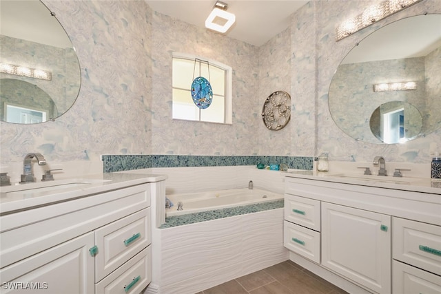 bathroom featuring vanity and a relaxing tiled tub