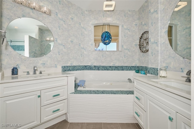 bathroom featuring vanity, tiled tub, and tile patterned floors