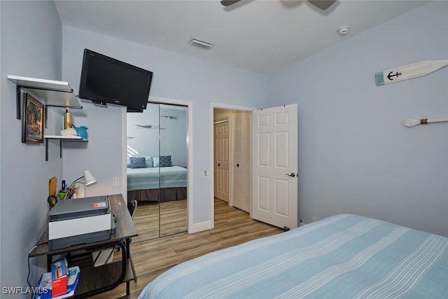 bedroom with hardwood / wood-style flooring, a closet, and ceiling fan