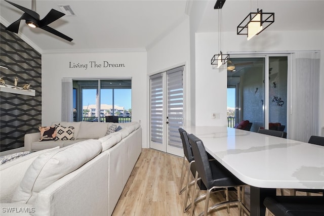 office space with light hardwood / wood-style floors, crown molding, and ceiling fan