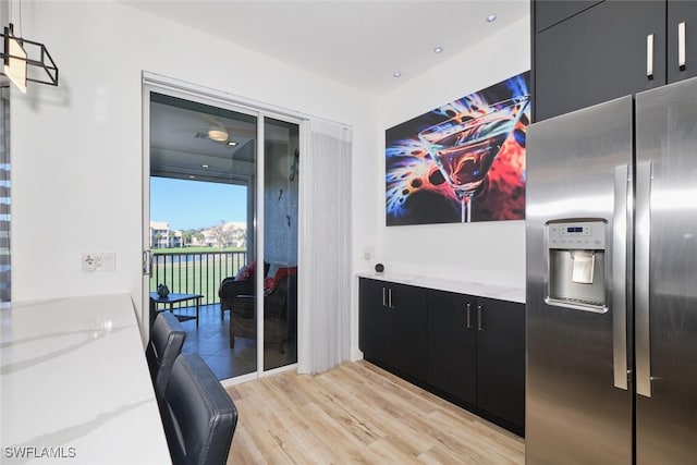 kitchen featuring light hardwood / wood-style floors and stainless steel fridge with ice dispenser