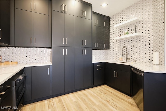 kitchen with light hardwood / wood-style flooring, tasteful backsplash, sink, and dishwasher