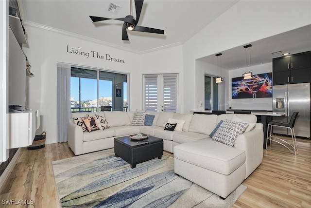 living room featuring ornamental molding, lofted ceiling, light hardwood / wood-style floors, and ceiling fan