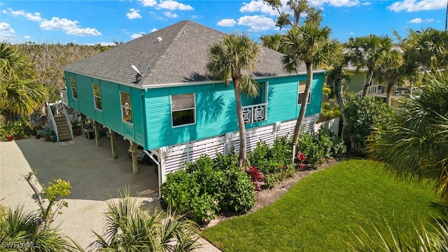 exterior space featuring a lawn and a carport