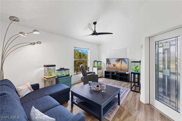 living room with light hardwood / wood-style flooring and ceiling fan