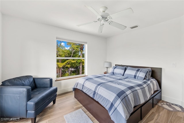 bedroom with light hardwood / wood-style flooring and ceiling fan