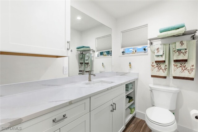 838-840 Rabbit Rd, Sanibel, FL 33957 - bathroom with baseboards, wood finished floors, toilet, and vanity