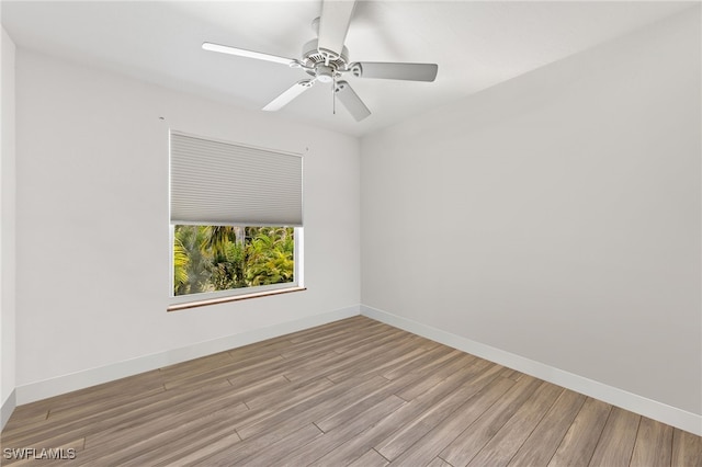 spare room featuring light hardwood / wood-style floors and ceiling fan